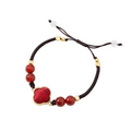 Gambiered Canton Gauze Four-Leaf Clover Bracelet – Red and Green, styled flat lay