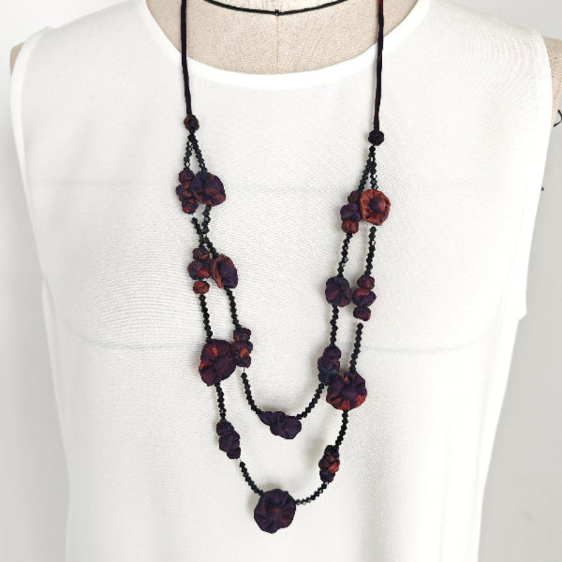 Xiangyunsha fabric bead layered necklace in forest green styled on mannequin